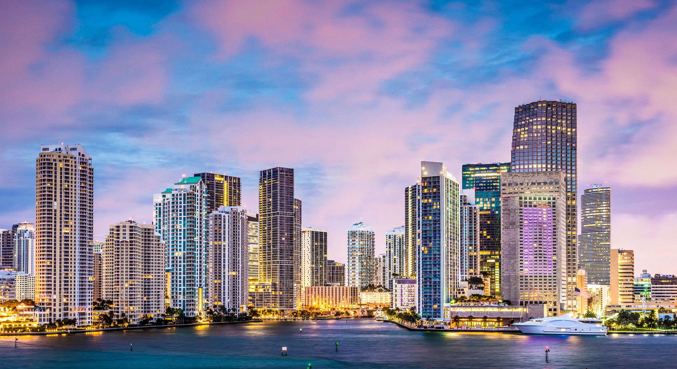 Miami skyline at sunset with waterfront view.