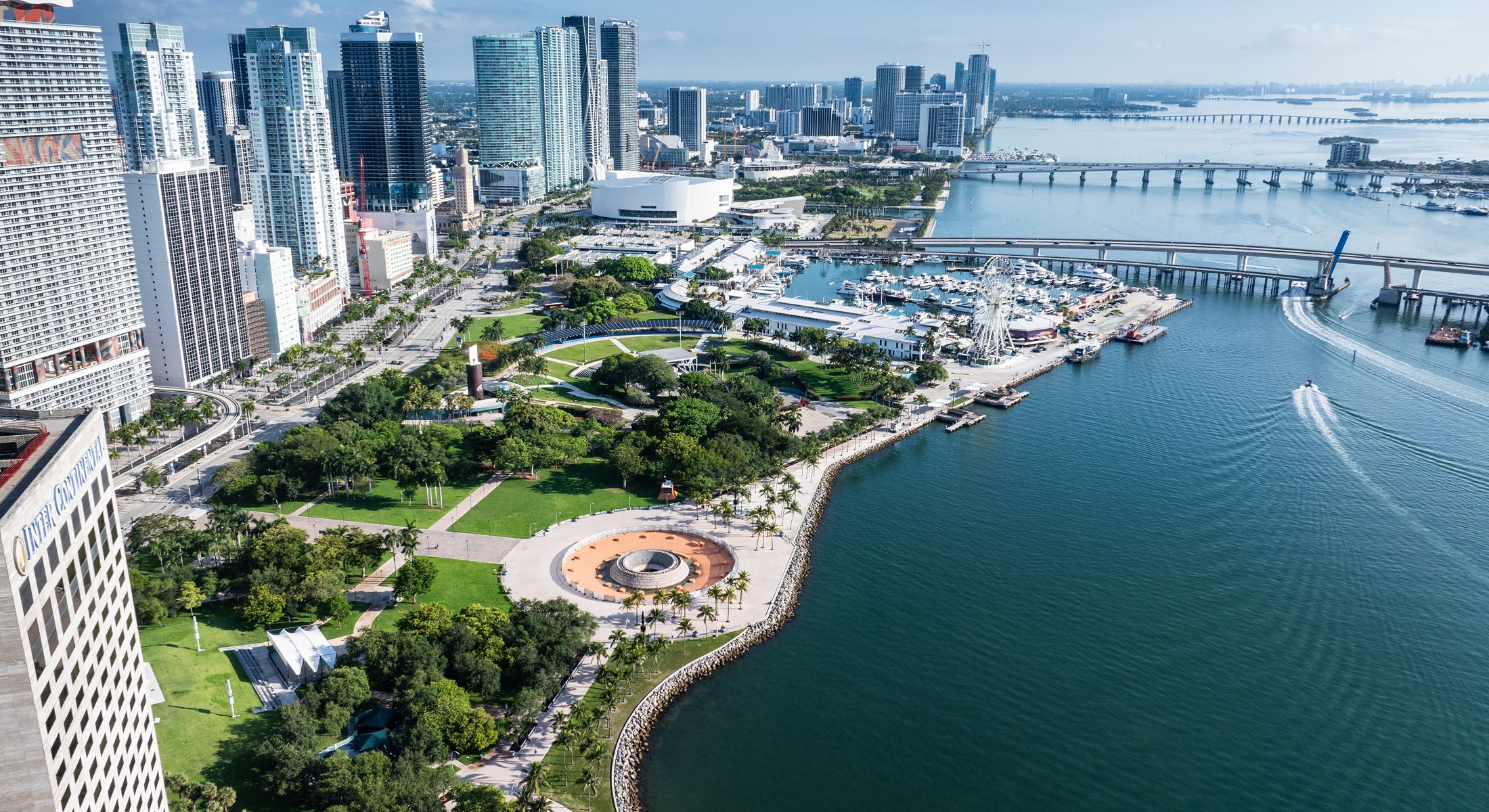 Miami waterfront with skyline and recreational area.