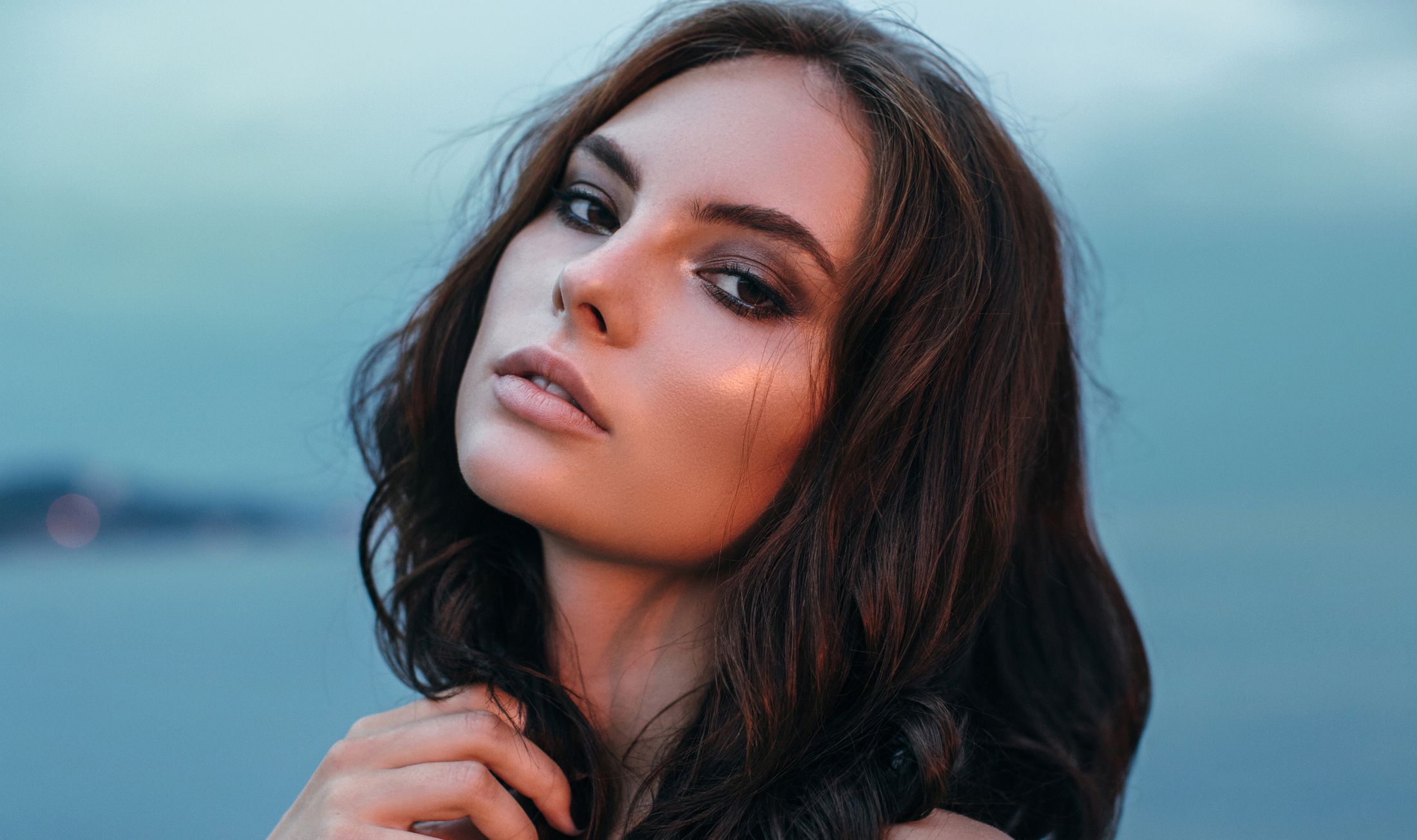 Close-up portrait of a woman with flowing hair.