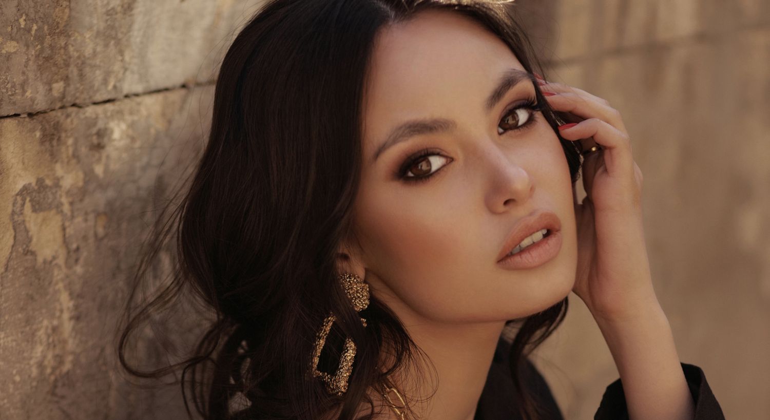 Woman with long hair against a soft background.